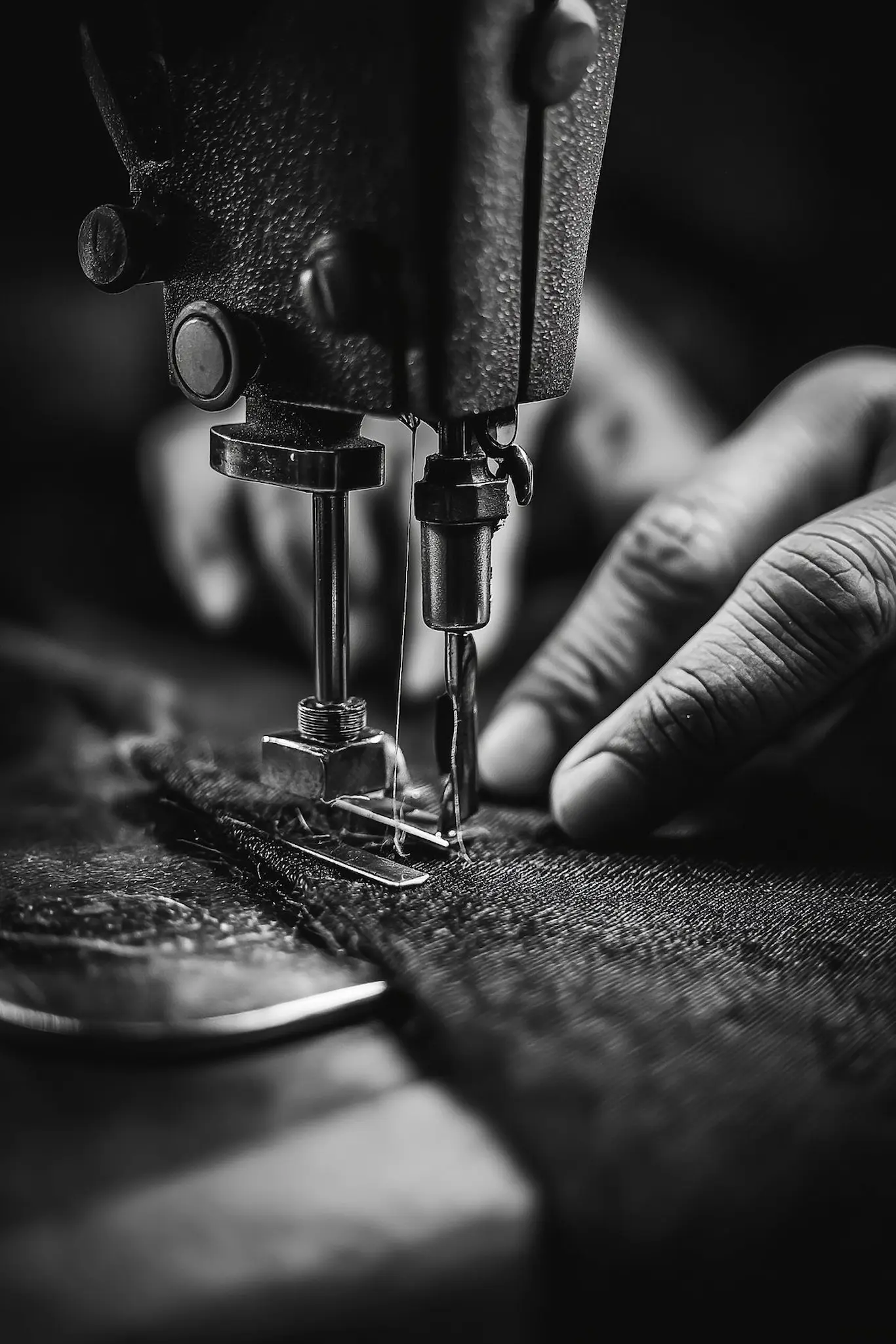 A machinist guiding mosquito net fabric through an industrial sewing machine